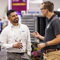 Events and Membership hero image Image of two men engaging at Cultivate