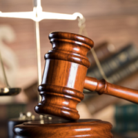 Image of gavel with scales in the background